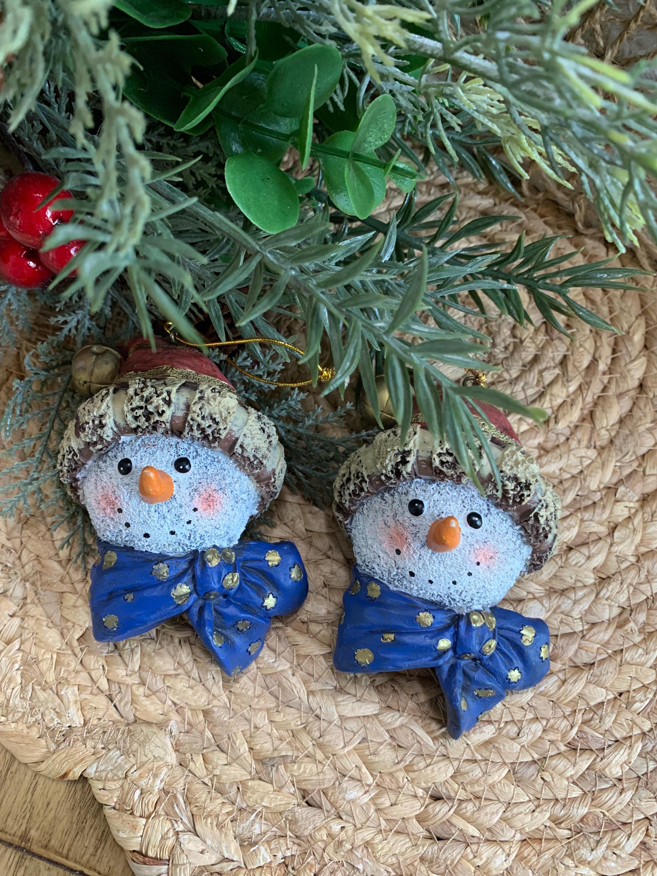 Set of 2 Snowman Head Ornaments – Rustic Resin with Blue Bow & Santa Hat