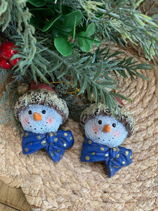 Set of 2 Snowman Head Ornaments – Rustic Resin with Blue Bow & Santa Hat