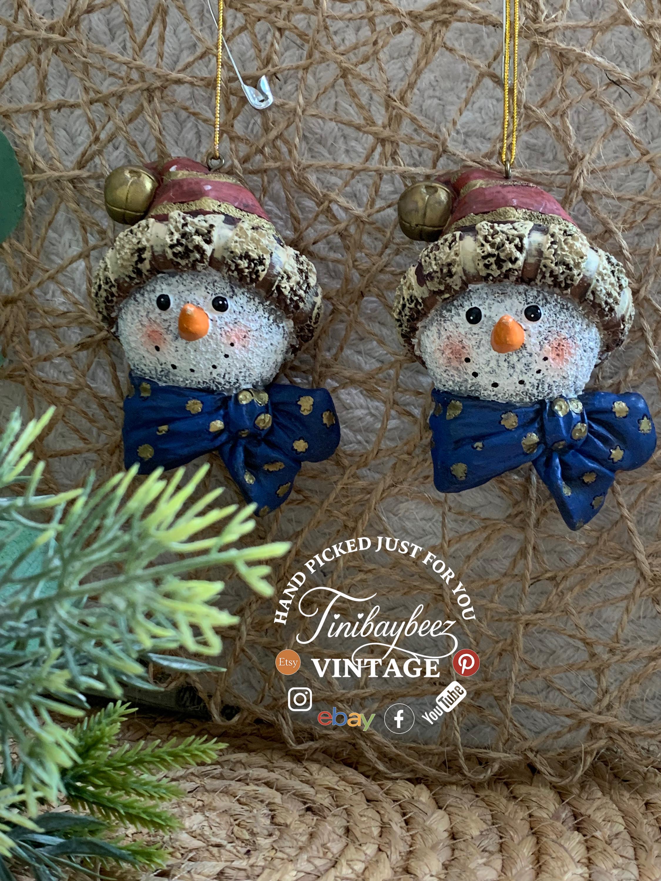 Set of 2 Snowman Head Ornaments – Rustic Resin with Blue Bow & Santa Hat